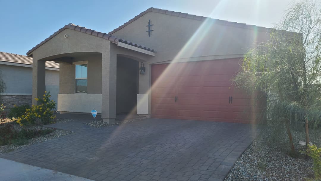 Home exterior with desert landscaping and a warm, welcoming facade